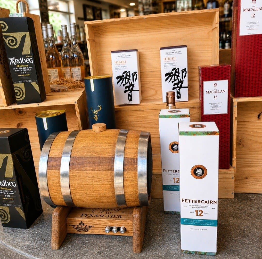 The oak barrel speaker on show among whisky bottles in a shop
