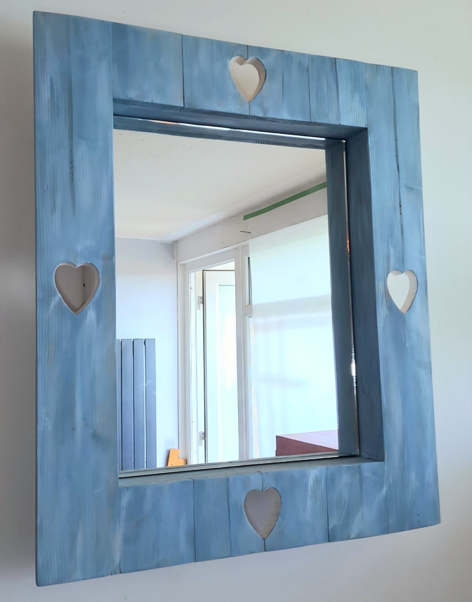 Mirror in a weathered blue timber frame with a heart cut into each side