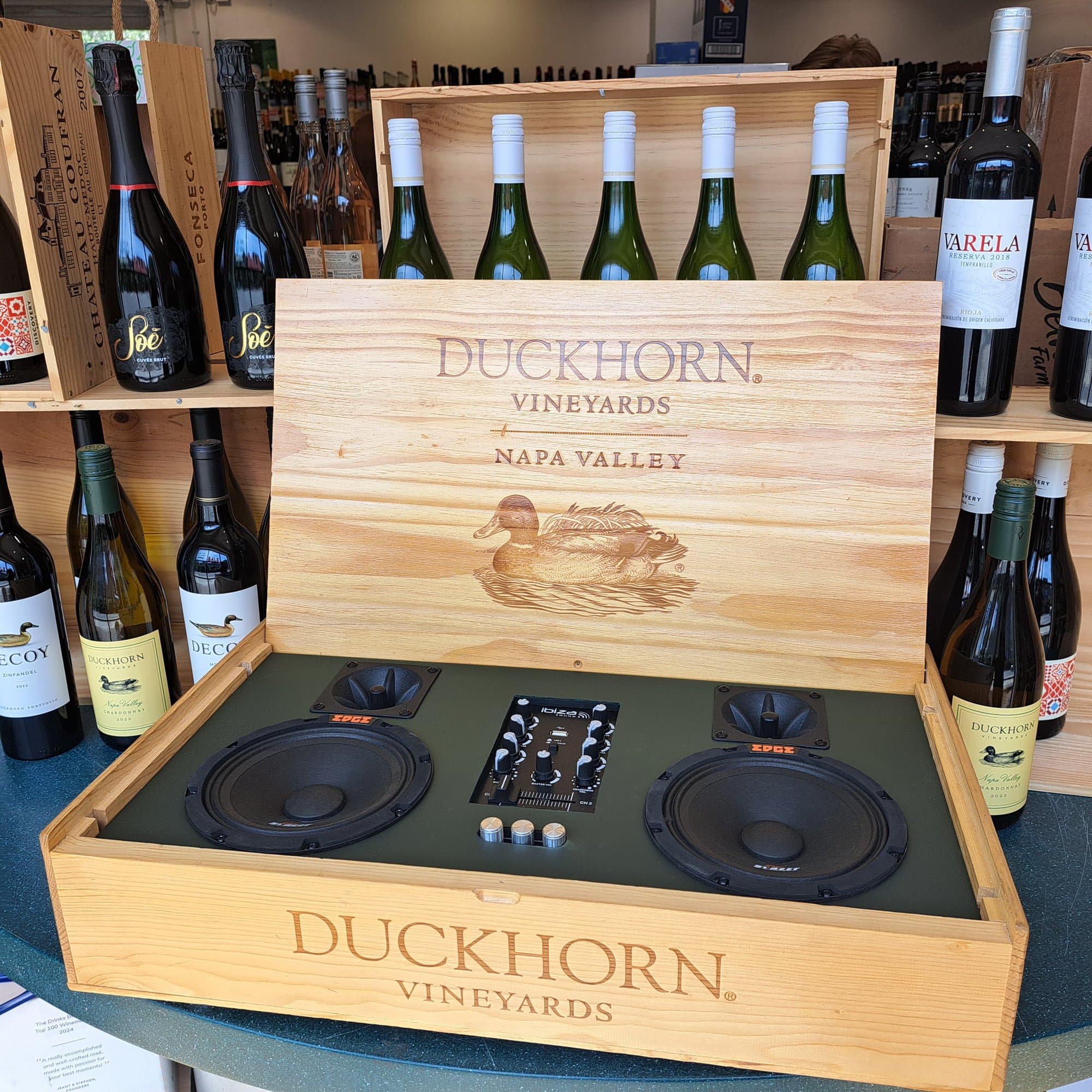 The Duckhorn wine box speaker open on a wine shop shelf