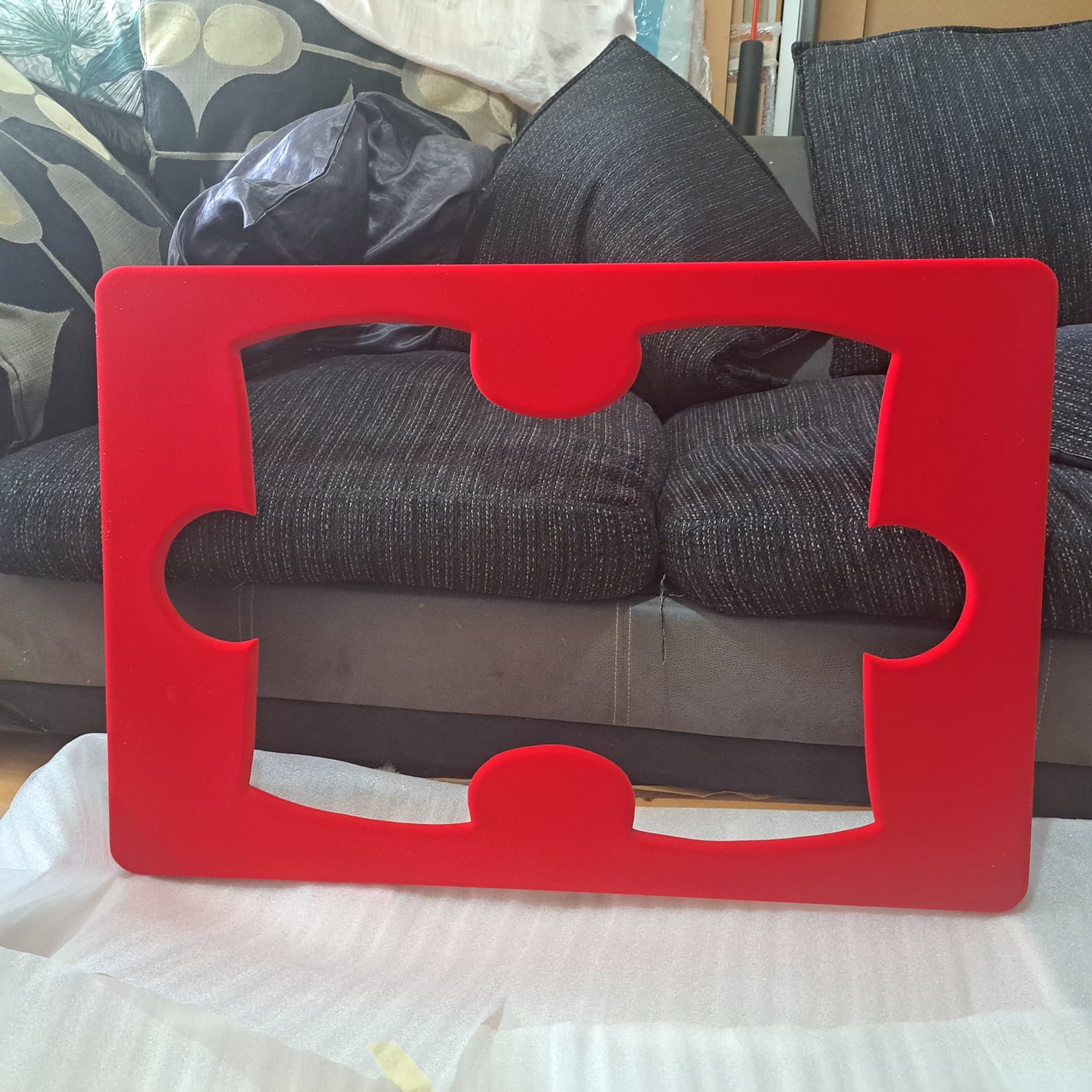 Mirror framed as a red jigsaw puzzle piece