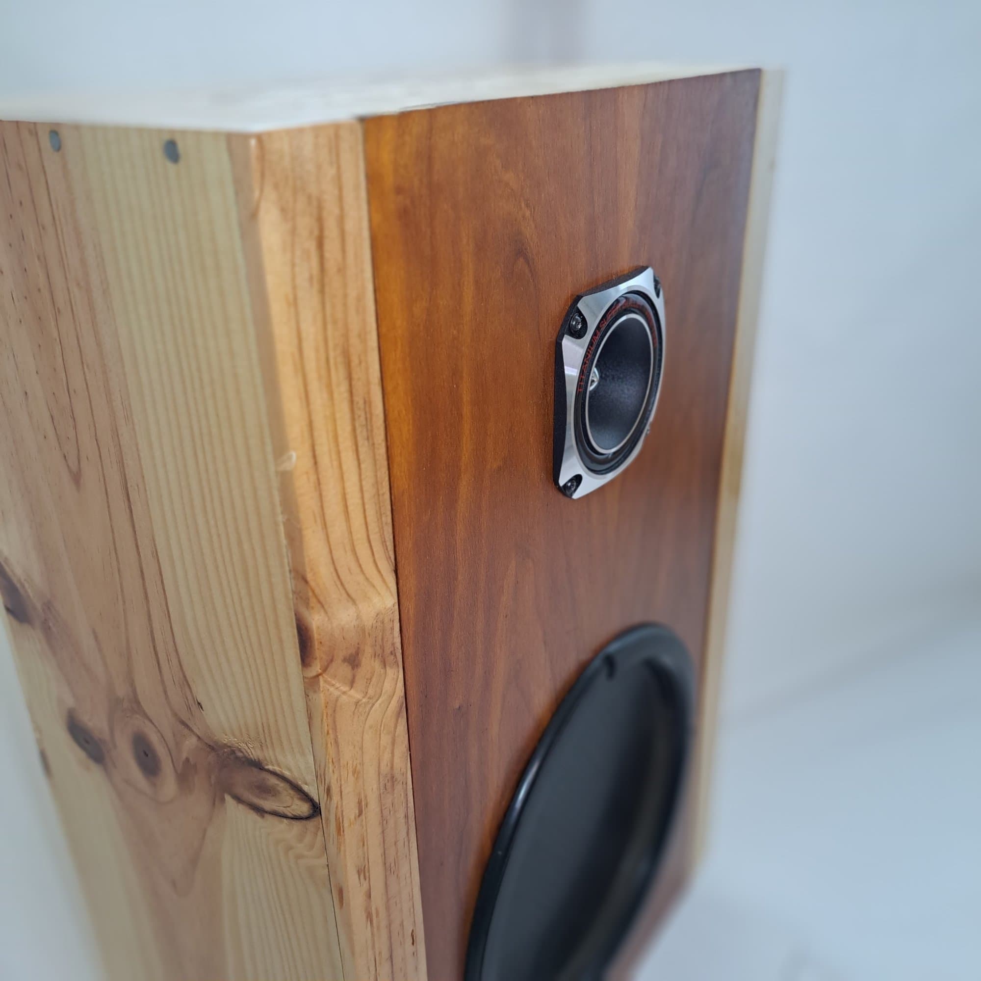 Solid pine block speaker with a small tweeter and a woofer