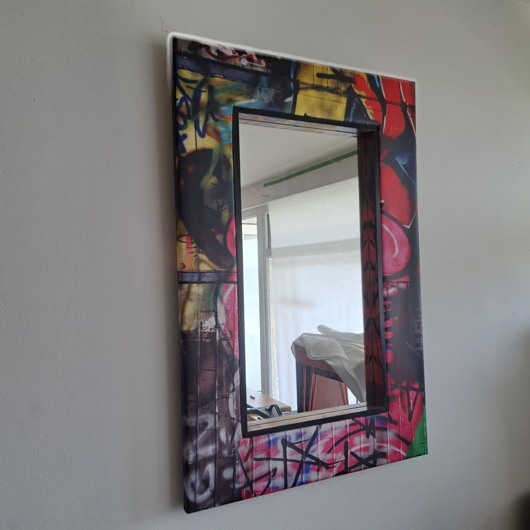 Mirror with a graffiti patterned frame
